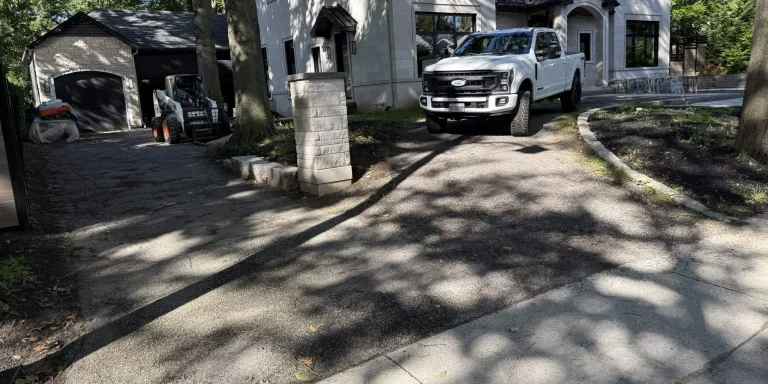 Hardscape construction in progress with a prepared base and stone pillar at an Oakville estate home